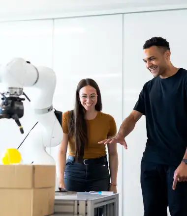 image of a man and woman working on a robot